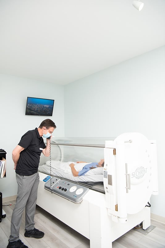 Therapiest while patient is under the chamber for HBOT at Charlottesville Hyperbarics